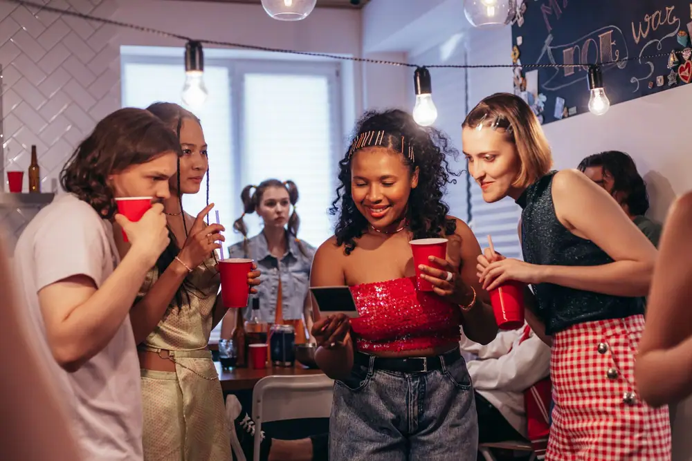 A large group of young adults celebrating together at a house party